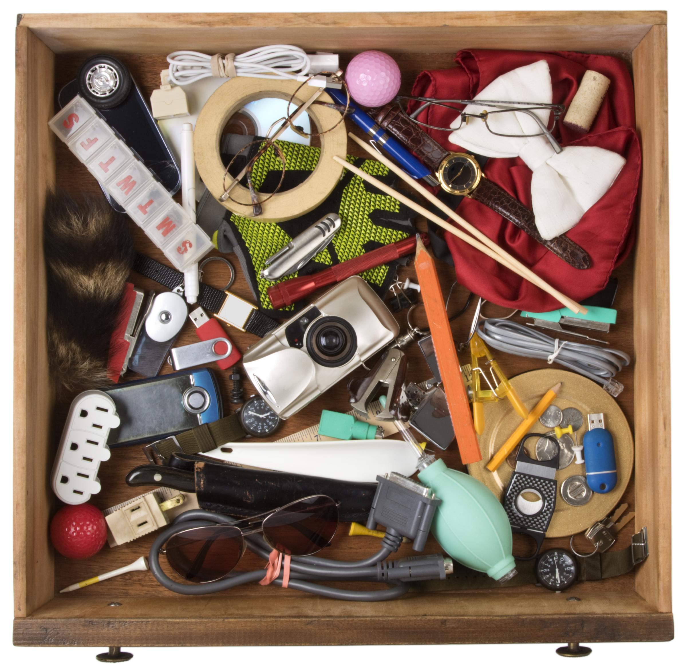 A photo of a junk drawer full of miscellaneous objects
